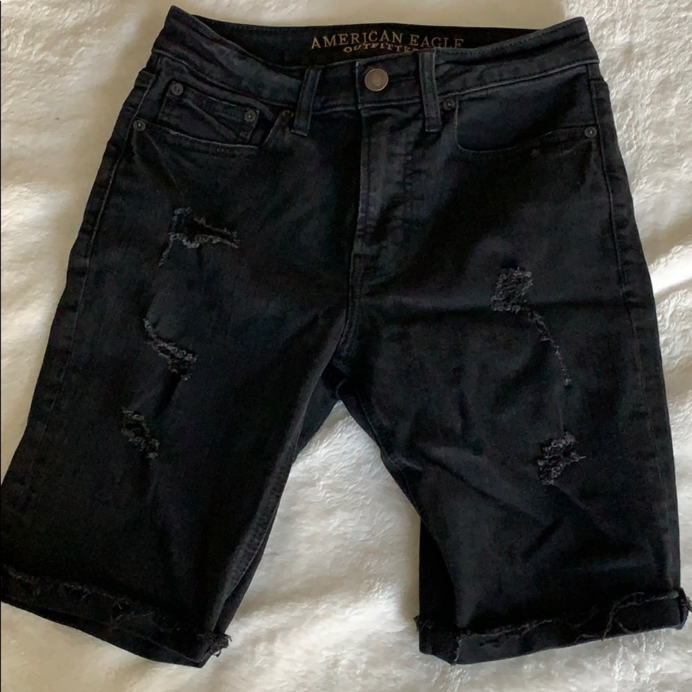 Distressed black jean shorts.